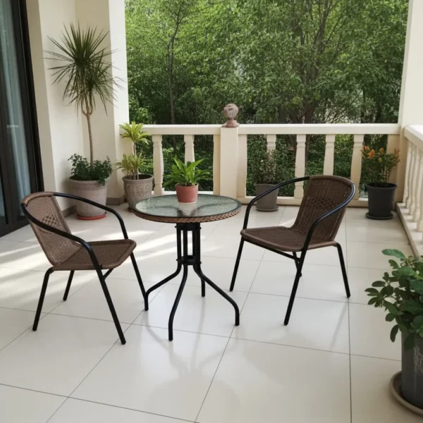 Outdoor Patio Bistro Set with round glass table and two brown woven rattan chairs set on a pool deck by the water.
