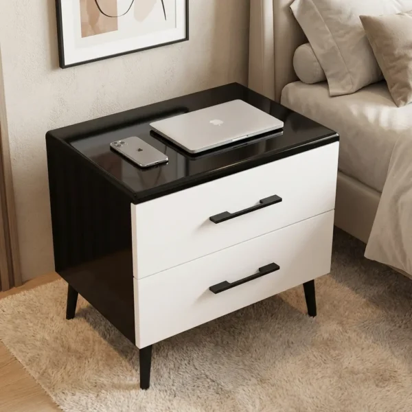 Black White Bedside Table in high-gloss black and white finish with two drawers set on a textured rug next to a bed.