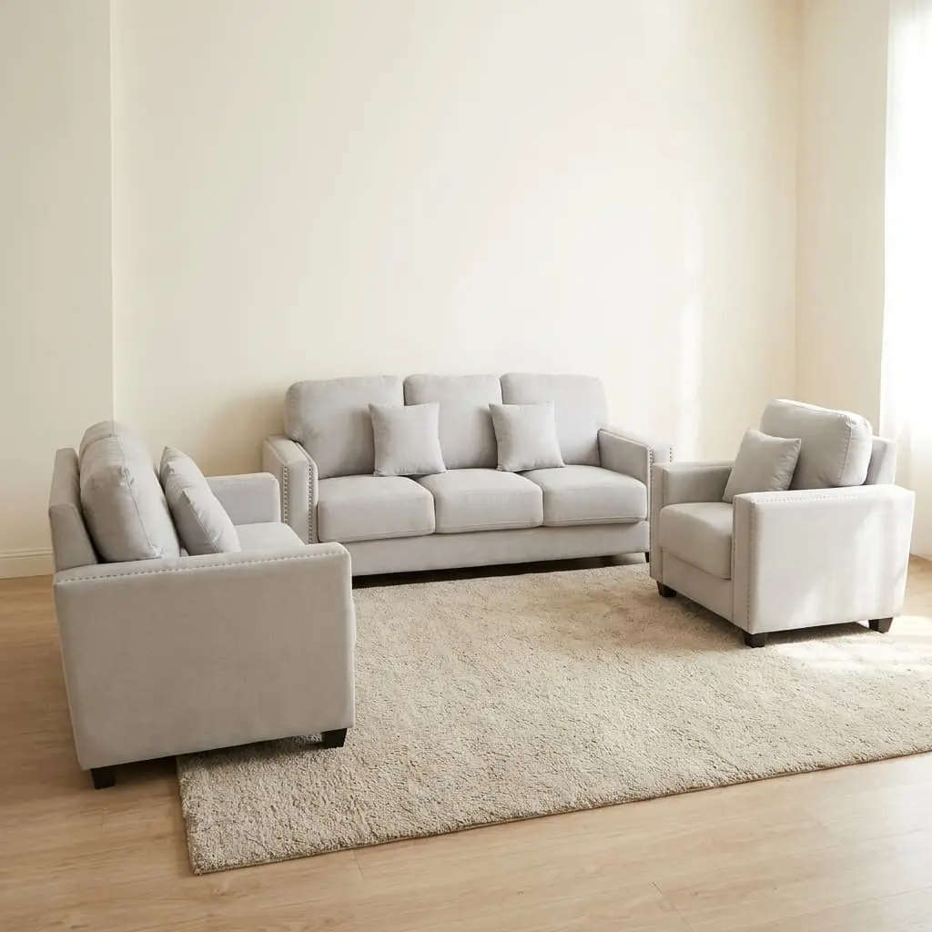 Three Piece Sofa Set in off-white velvet with nailhead trim including a 3-seater, 2-seater loveseat, and armchair on a rug.
